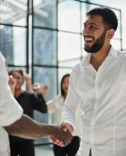 Businessmen reach out to each other to shake hands Meeting in den elaya hotels.