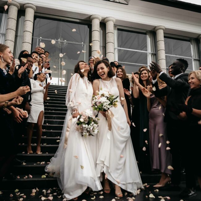 Female lesbian LGBT brides walking down the stairs during their wedding ceremony Private Feiern in den elaya hotels.